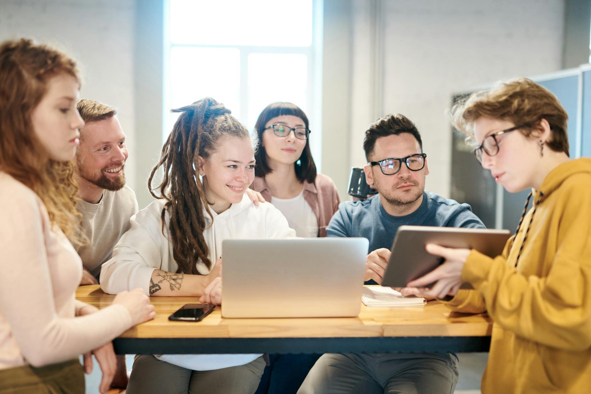 Diverse team brainstorming with technology — MAMAJI