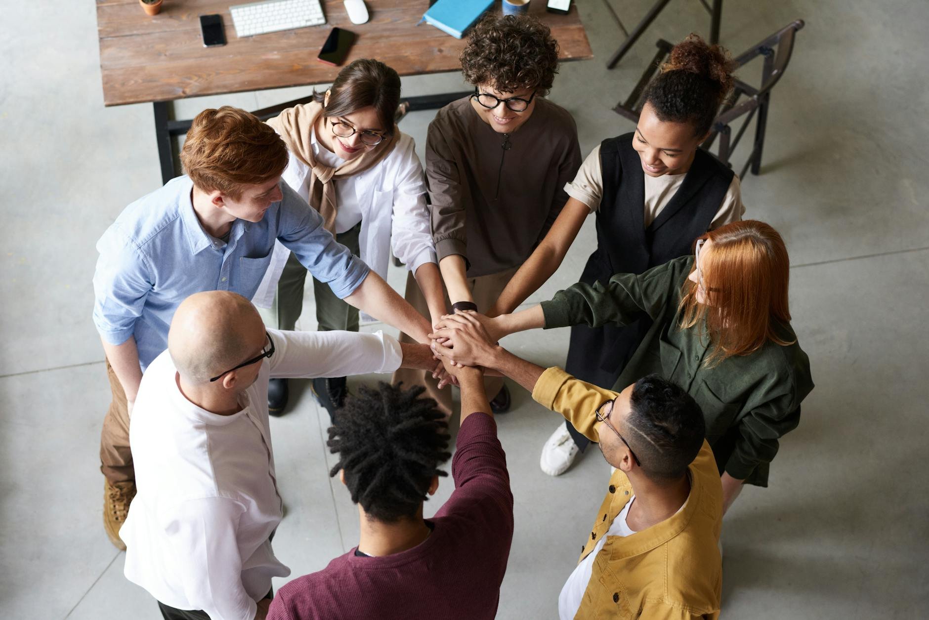 Top view of diverse team collaboration — MAMAJI